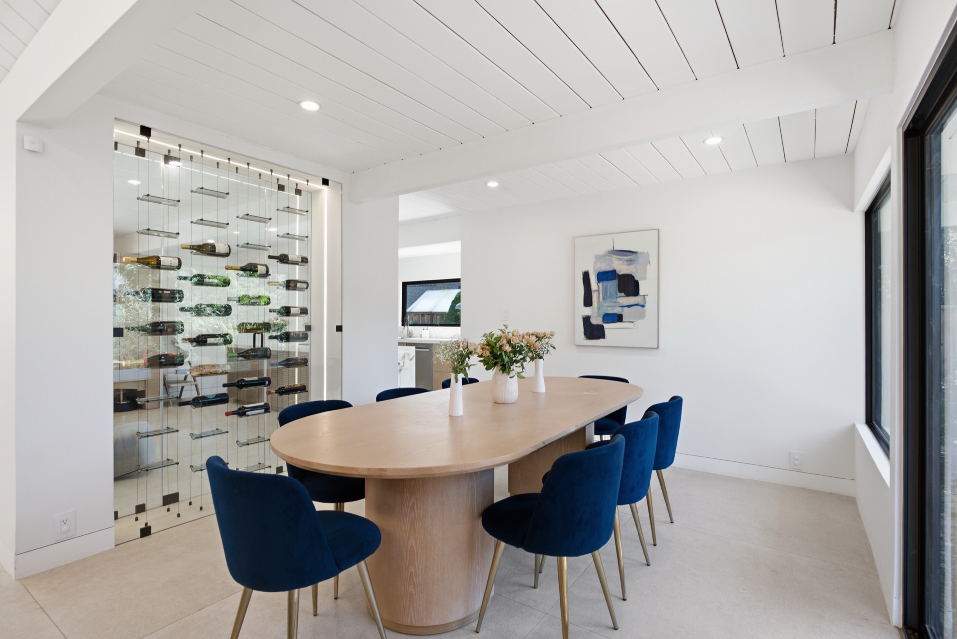 Dining room with suspended glass wine wall