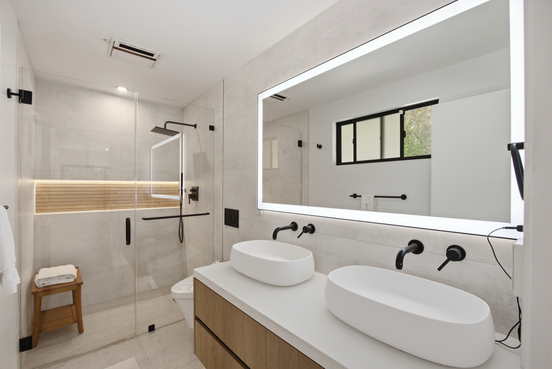 Spa primary bathroom with dual vessel sinks and rain shower